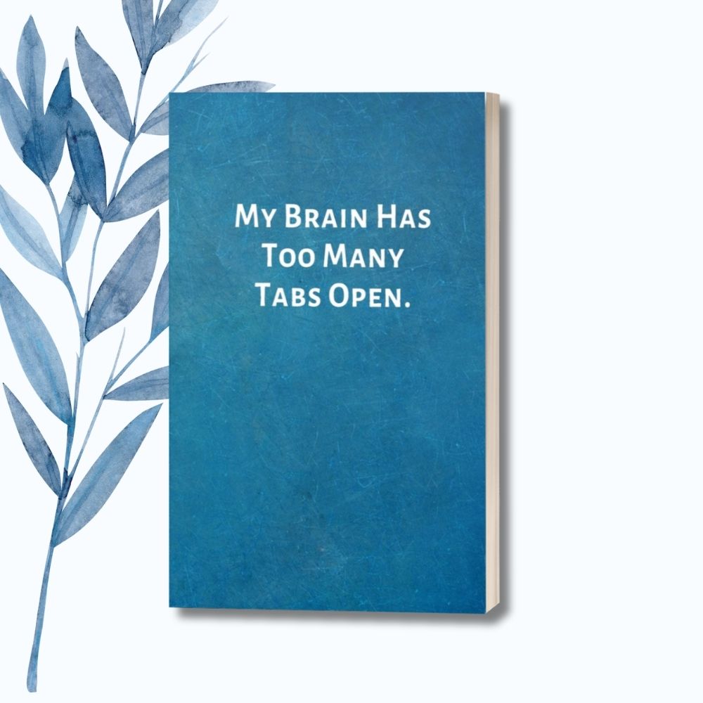 A notebook featuring the phrase "My Brain Has Too Many Tabs Open" on a sleek glossy cover.