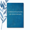 A notebook featuring the humorous phrase "Congratulations on Your Escape" on a glossy, celebratory cover.