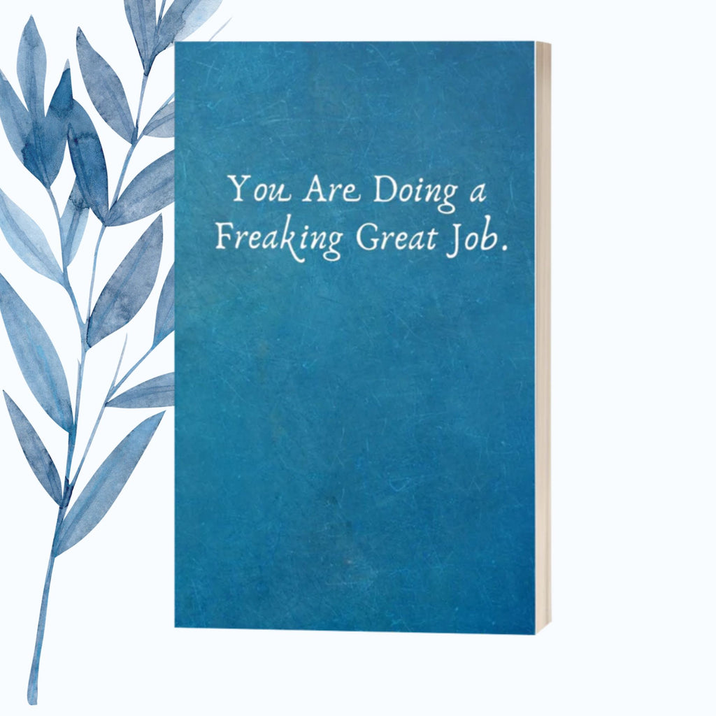 A notebook featuring the phrase "You Are Doing a Freaking Great Job" on a glossy, motivational cover.