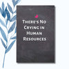 A notebook featuring the phrase "There’s No Crying in Human Resources" on a sleek, glossy cover.