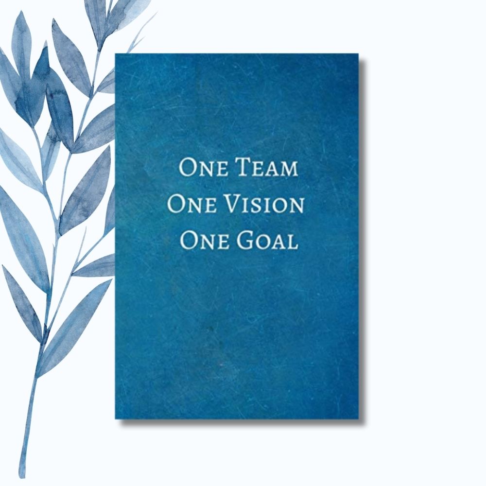 A notebook featuring the motivational phrase "One Team, One Vision, One Goal" on a sleek, glossy cover.