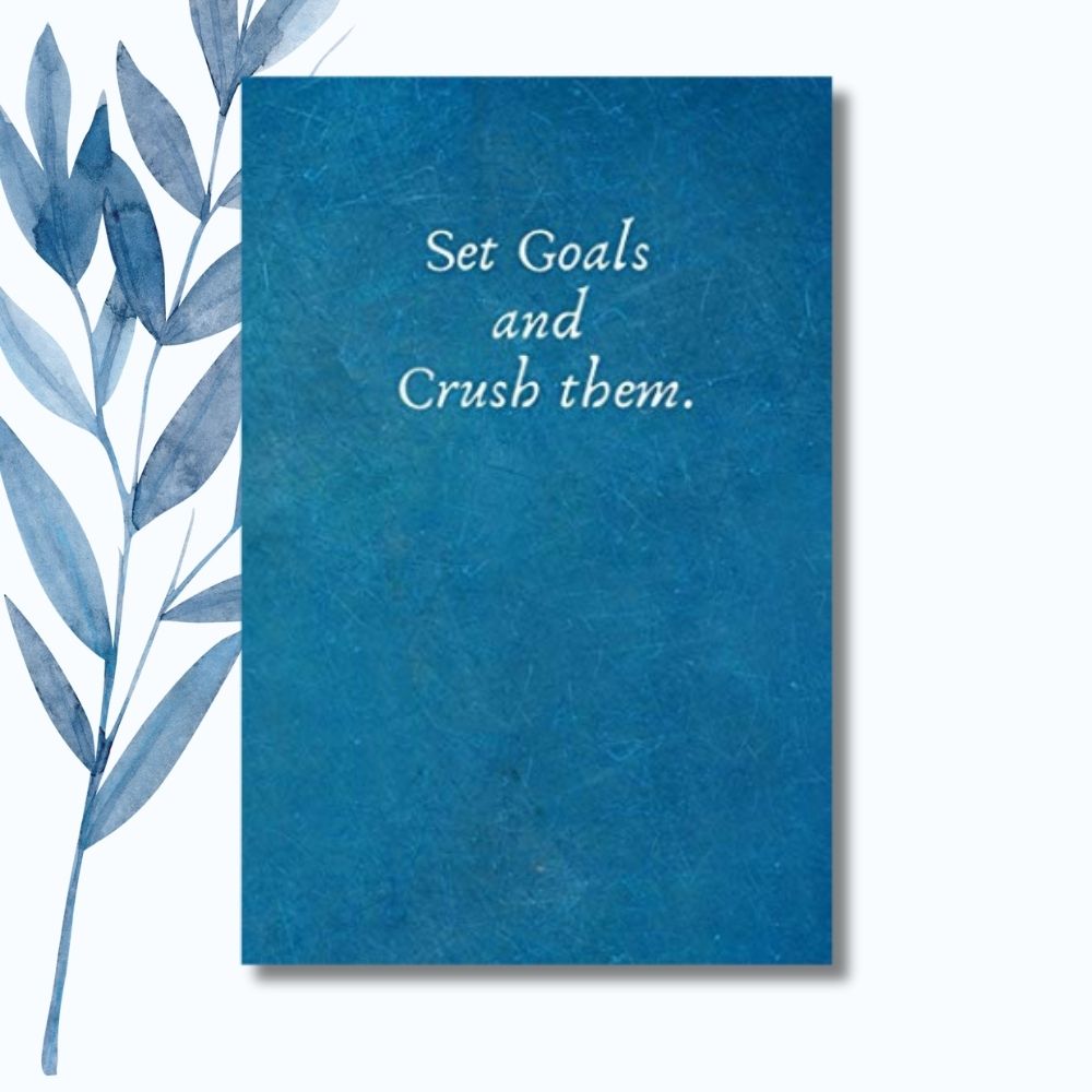 A notebook featuring the motivational phrase "Set Goals and Crush Them" on a sleek, glossy cover.