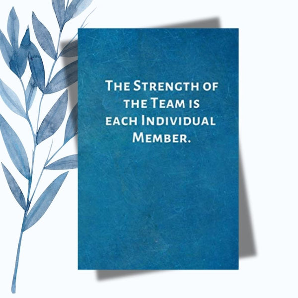 A notebook with the phrase "The Strength of the Team Is Each Individual Member" on a sleek, glossy cover.