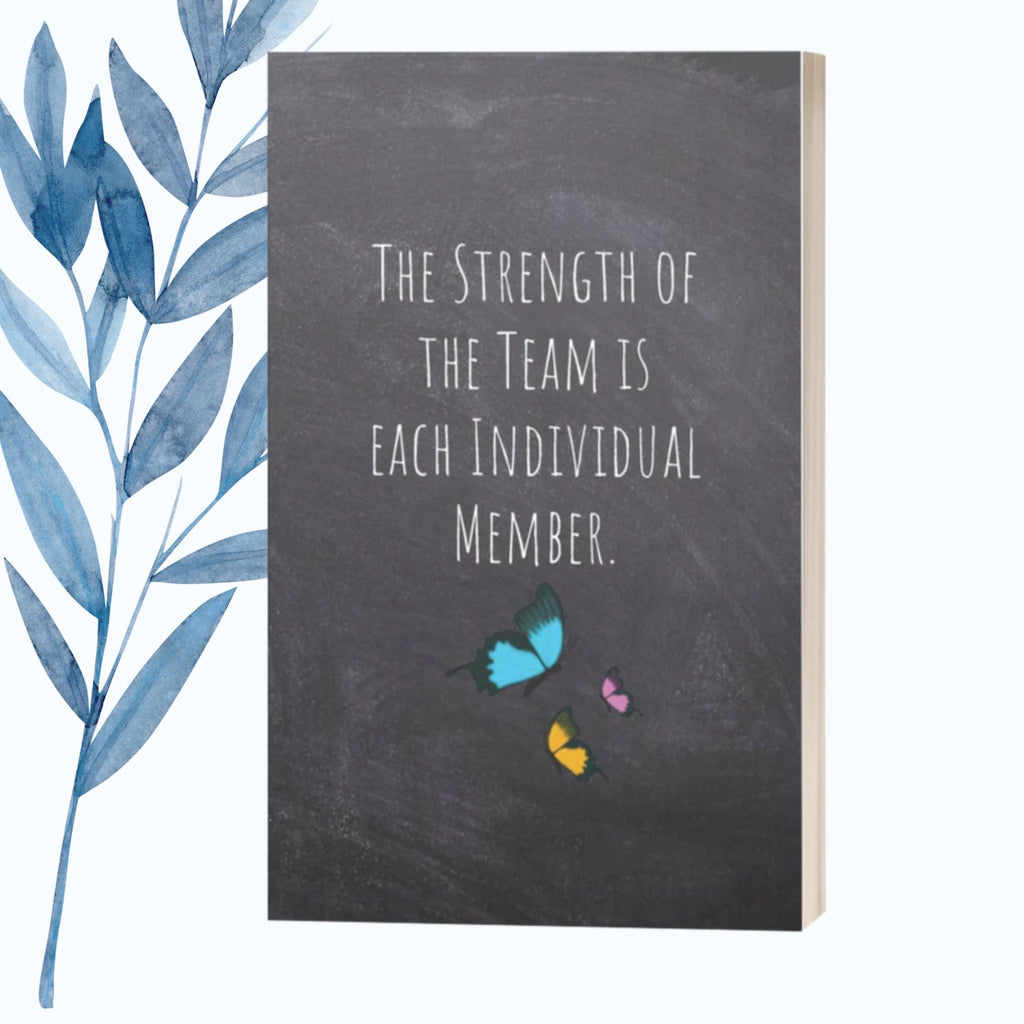 A notebook featuring the phrase "The Strength of the Team Is Each Individual Member" on a glossy, motivational cover.