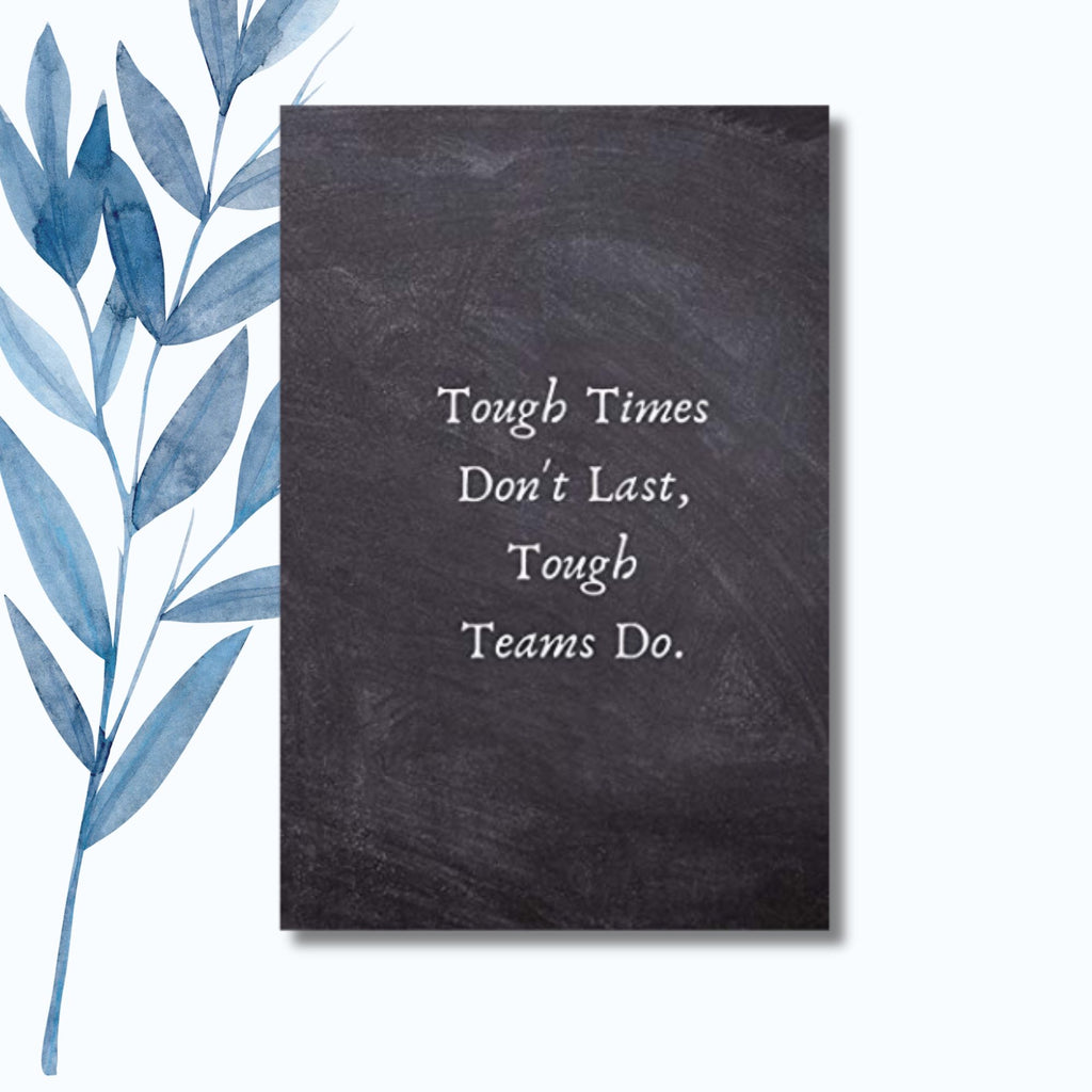 A notebook with the phrase "Tough Times Don’t Last, Tough Teams Do" on a black chalkboard-style cover.