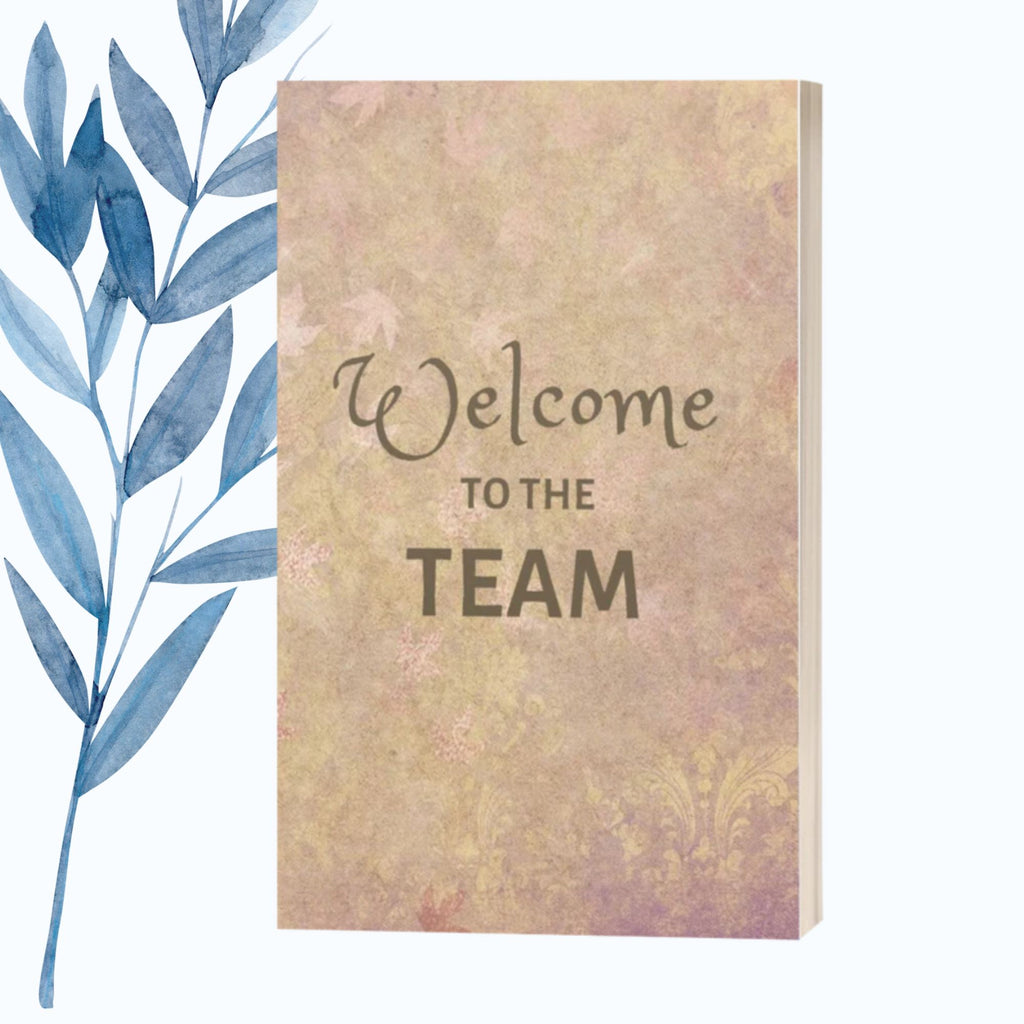 A notebook featuring the phrase "Welcome to the Team" on a sleek, glossy cover.